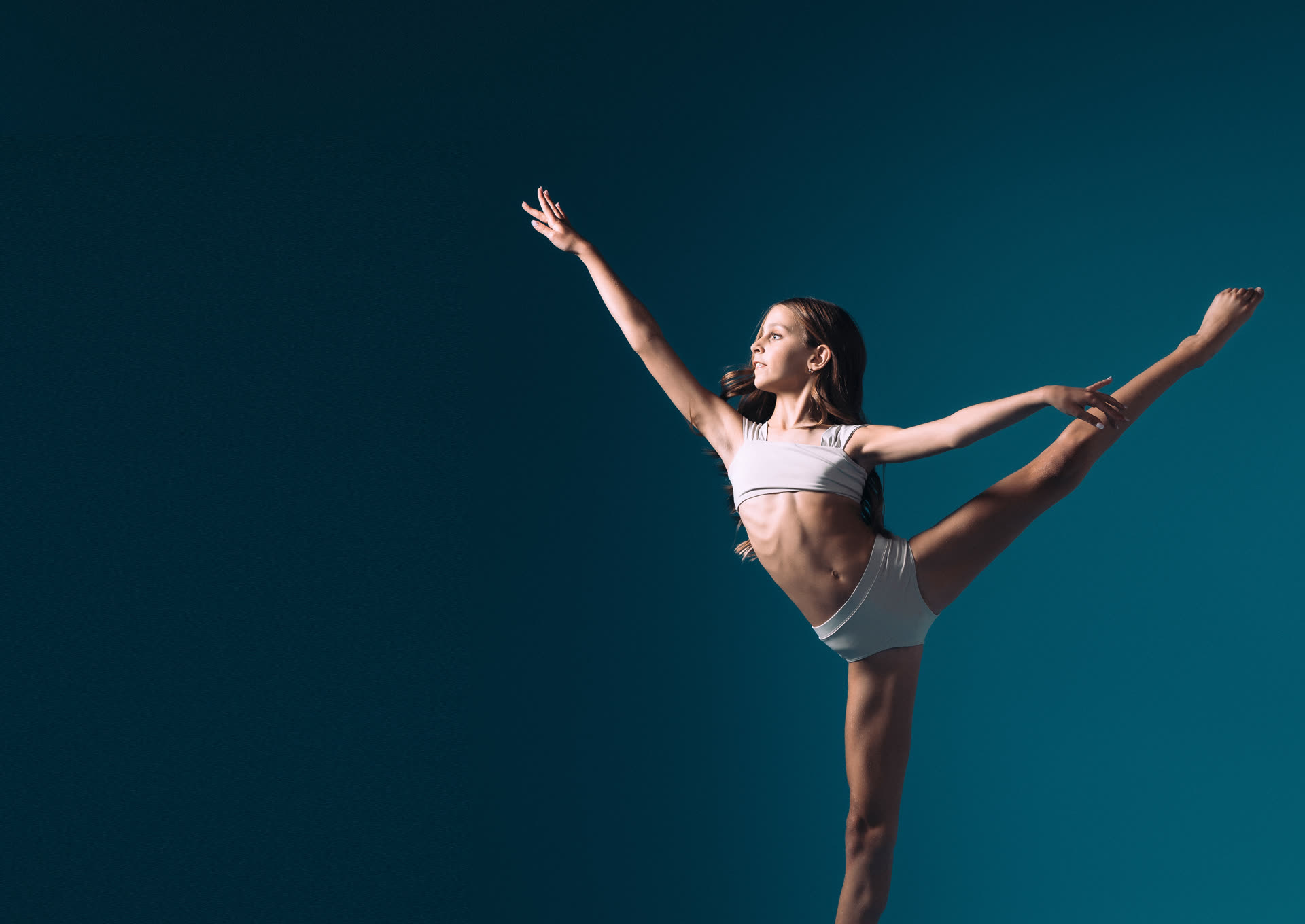 Young dancer balancing in arabesque