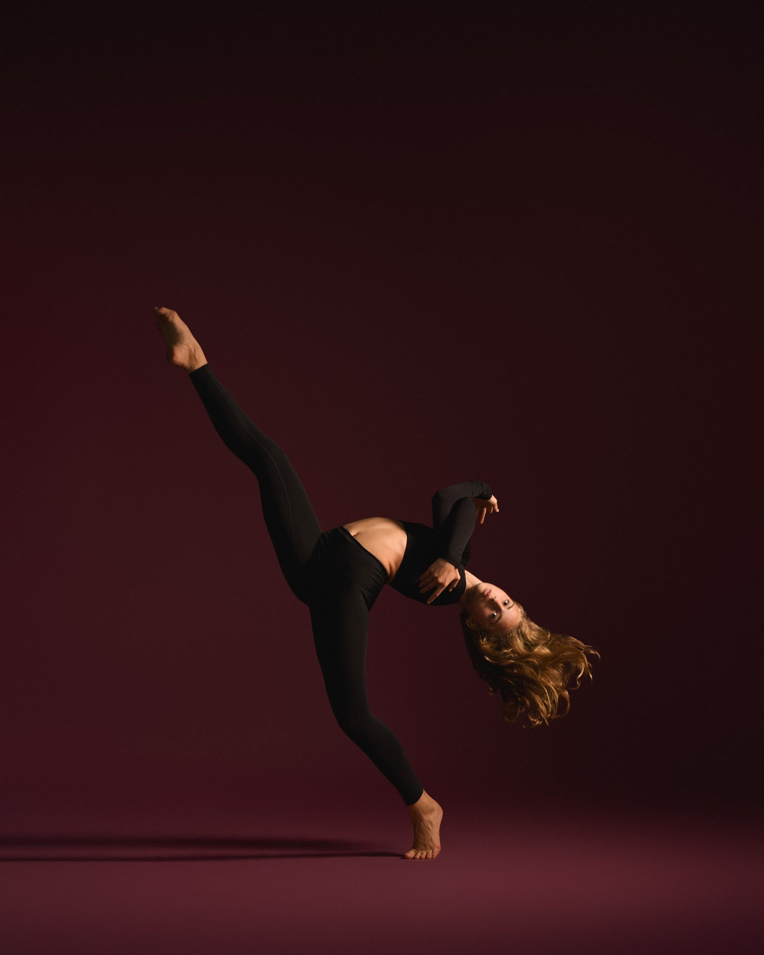 Dancer in a tilted kick extension